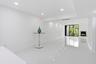 Recessed lighting, polished tile flooring, white walls, and a fireplace with a stone surround