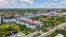 Waterfront property with multiple residential buildings, surrounded by mature landscaping and a well-maintained road