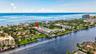 Waterfront property with canal and ocean access, surrounded by lush landscaping and residential structures