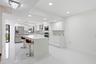 Contemporary kitchen featuring a large island, white cabinetry, stainless steel appliances, and a chevron tile backsplash