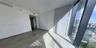 Floor-to-ceiling glass windows, neutral wood-finish flooring, and recessed ceiling lighting