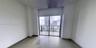 Room featuring large-format tile flooring, floor-to-ceiling sliding glass doors, and a private balcony with metal railings