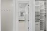Custom fitted his and hers closets in Primary Suite leading to bathroom