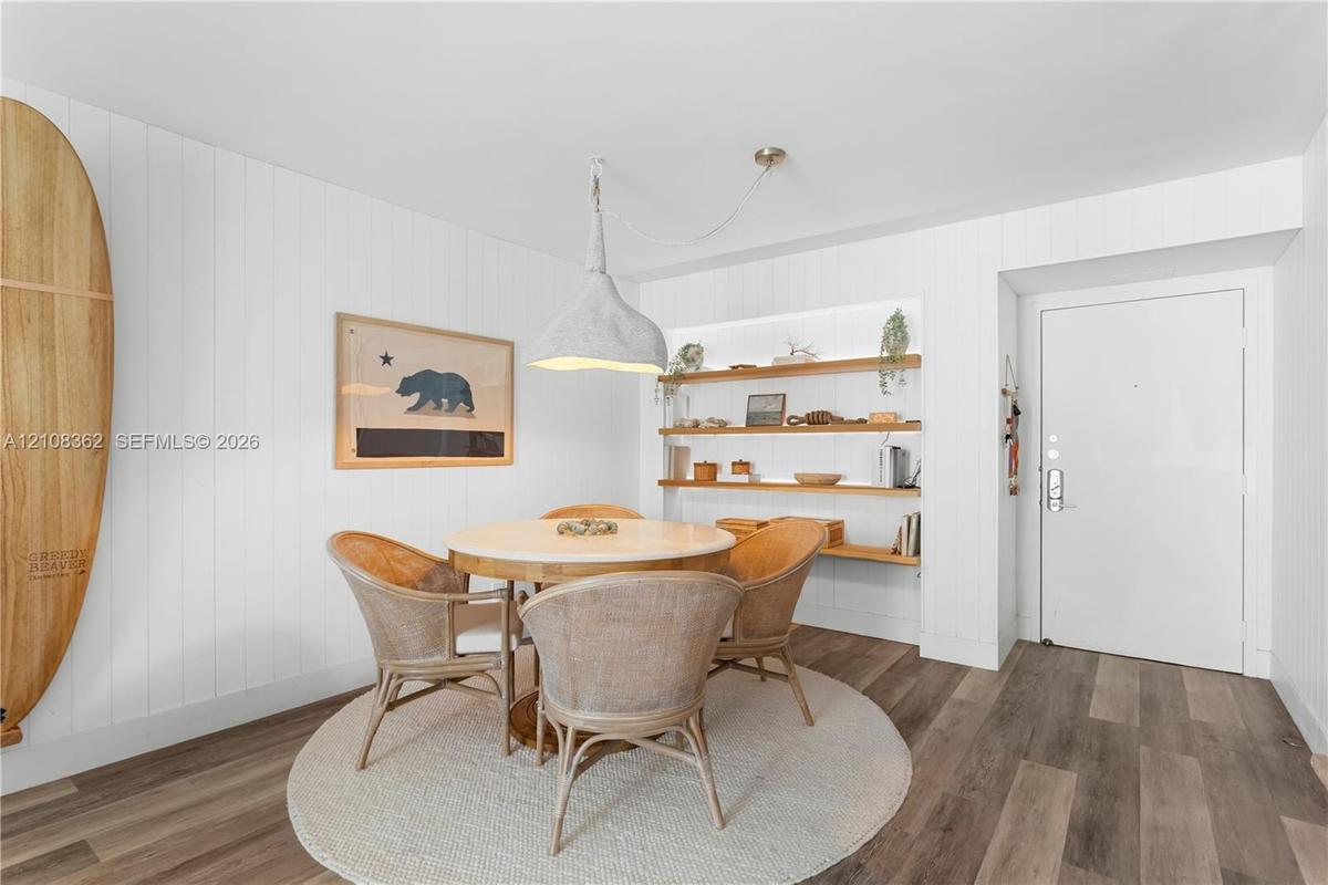 Vertical white plank wall paneling, integrated recessed shelving with under-shelf lighting, and wood-finish flooring