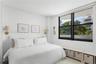 Vertical wood paneling, large windows with black frames, and integrated wall-mounted light fixtures