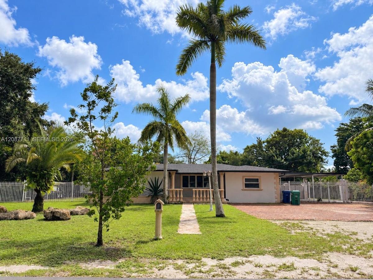 Single-story residence featuring a paved front walkway, decorative balustrade porch railing, exterior accent stone detailing, a brick-paved driveway, 