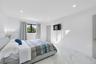 Bright room featuring polished white stone-finish flooring, recessed LED lighting, and a window with black frames