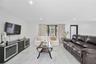 Living area featuring large-format tile flooring with a neutral veined pattern and recessed ceiling lighting