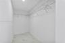 Walk-in closet featuring stone-patterned tile flooring and wrap-around wire shelving