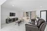 Polished stone-look flooring, recessed lighting, and expansive glass sliding doors