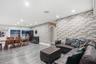 Interior space featuring full-height textured brick accent walls, wood-finish flooring, recessed lighting, and a sliding glass door