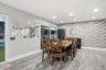 Textured brick accent wall, wood-finish flooring, recessed lighting, and sliding glass door