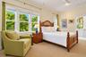 Room featuring multi-pane windows, crown molding, ceiling-mounted track lighting, and wall-to-wall carpeting