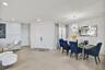 Open-concept space featuring neutral large-format tile flooring, recessed ceiling lighting, a contemporary multi-point starburst chandelier, and doubl