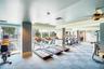 Fitness center featuring checkered flooring, recessed lighting, ceiling fan, and floor-to-ceiling windows