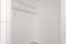 Storage area featuring dual-tiered white wire shelving