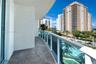 Curved balcony featuring stone-tile flooring and glass panel railings