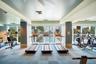 Fitness center featuring expansive floor-to-ceiling windows, blue tile flooring, and integrated wall mirrors