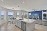 Central kitchen island with solid surface countertop, undermount sink, stainless steel dishwasher, tile flooring, and recessed lighting