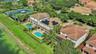 Two-story residence featuring a private swimming pool, solar panel array, tiled roof, and balconies with metal railings
