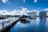 Waterfront location featuring a concrete dock, integrated boat lift, and metal railing