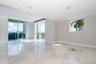 Large-format tile flooring, recessed ceiling lighting, floor-to-ceiling glass sliding doors, custom stone floor inlay, and expansive windows