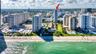 Aerial perspective of a high-rise residential structure situated along a coastal waterfront