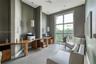 Built-in stone-top desk with integrated wood cabinetry, floor-to-ceiling multi-pane window, large-format tile flooring, and two modern pendant light f