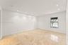 Interior space featuring large-format stone flooring, recessed ceiling lighting, and a single-pane window with integrated blinds