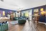 Spacious interior featuring wood-finish flooring, recessed ceiling fan, and large sliding glass doors providing natural light