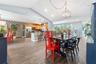 Open-concept interior featuring vaulted ceilings, wood-finish flooring, recessed lighting, and a kitchen peninsula with cabinetry