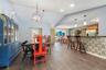 Vaulted ceilings, wood-finish flooring, recessed lighting, metal globe chandelier, and kitchen peninsula with bar-style seating