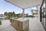 Outdoor cabinetry with Neolith Countertops and waterfall gas grill, fridge