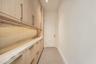 pantry floor to ceiling cabinetry , marble counter & backsplash and instahot faucet. ac closet at end of room