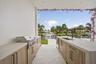 Outdoor cabinetry with Neolith Countertops and waterfall gas grill, fridge
