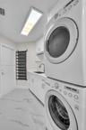 Laundry room with granite counter tops and sink