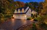 TWILIGHT VIEW OF 3 CAR GARAGE