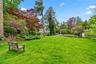 Two park like acres of level lawn and gardens
