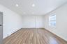 Neutral interior featuring wood-finish flooring, recessed lighting, and a multi-pane window