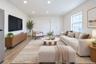 Living area featuring wood-finish flooring, recessed lighting, and a multi-pane window
