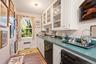 Butlers pantry/wet bar area with dishwasher, oven and sink