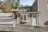 Conveniently located rear kitchen exit providing seamless, easy access to both the private backyard and the detached 2-car garage.