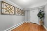 Bright and welcoming interior foyer featuring gleaming hardwood floors and crisp neutral tones.