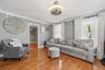 Another view of the open living room space, emphasizing the abundant natural light and easy flow.