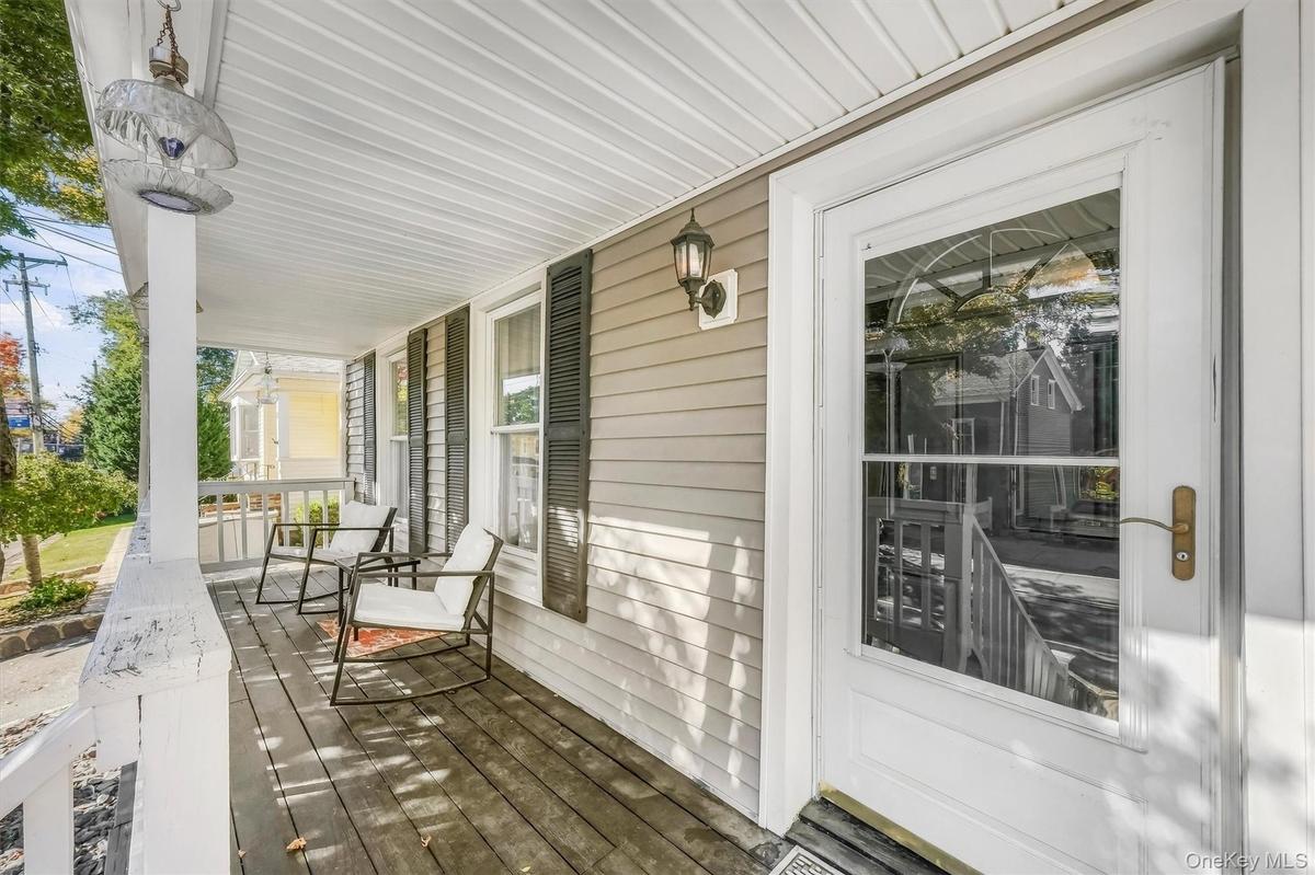 Welcoming covered front porch offering a charming space to relax and enjoy the neighborhood views.