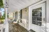 Welcoming covered front porch offering a charming space to relax and enjoy the neighborhood views.