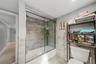 : Large, beautifully updated modern bathroom offering a spacious layout, sleek fixtures, and sophisticated styling.