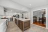 Alternate view of the kitchen workspace highlighting the efficient design and easy access to the main living areas.
