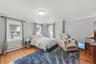 Spacious bedroom filled with natural light, featuring gleaming hardwood floors and a peaceful, inviting atmosphere.