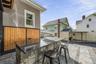 Backyard entertaining area equipped with a built-in gas grill and smoker, creating the ultimate setup for weekend barbecues and outdoor cooking enthus